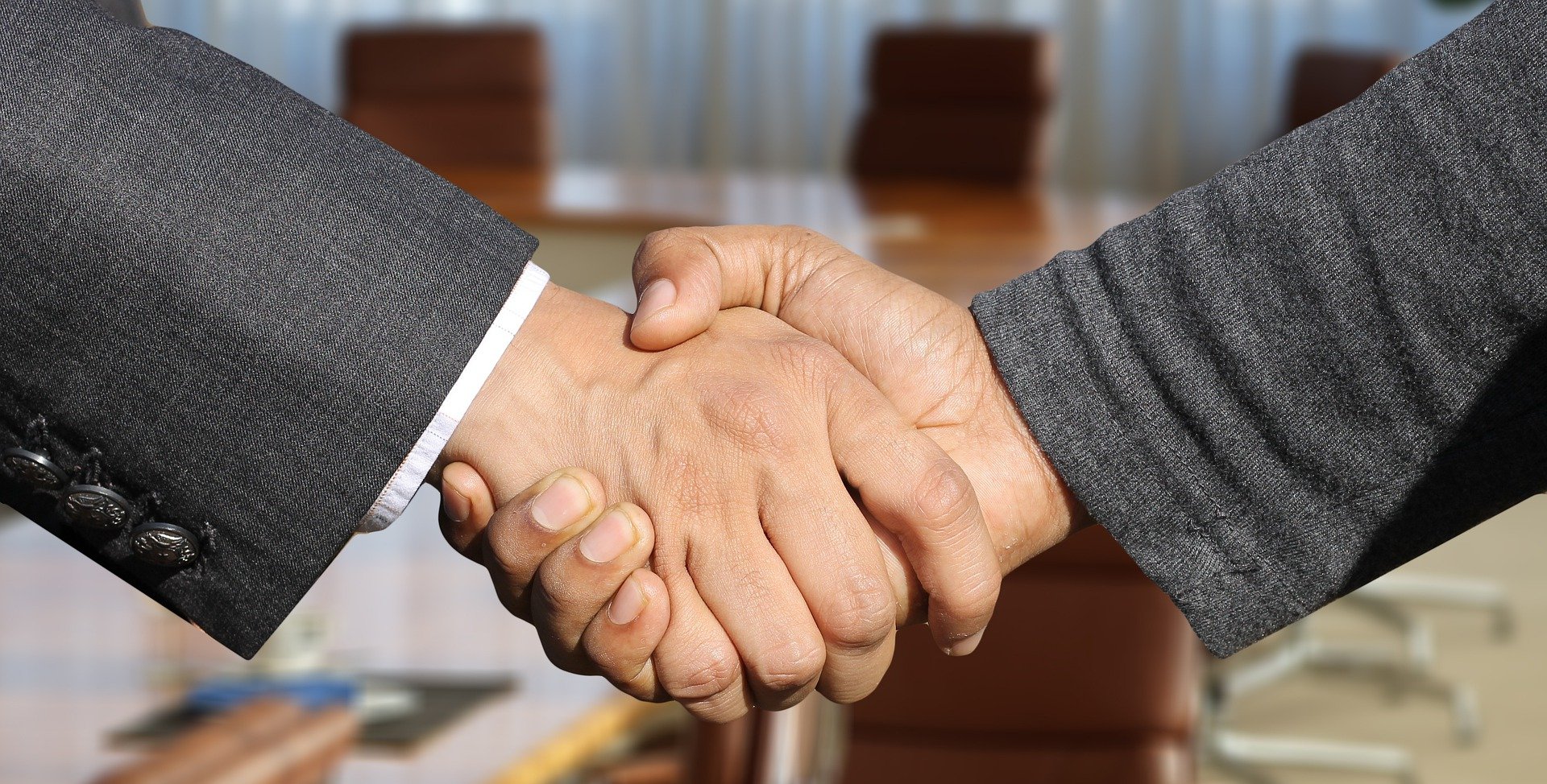 close up on two men shaking hands
